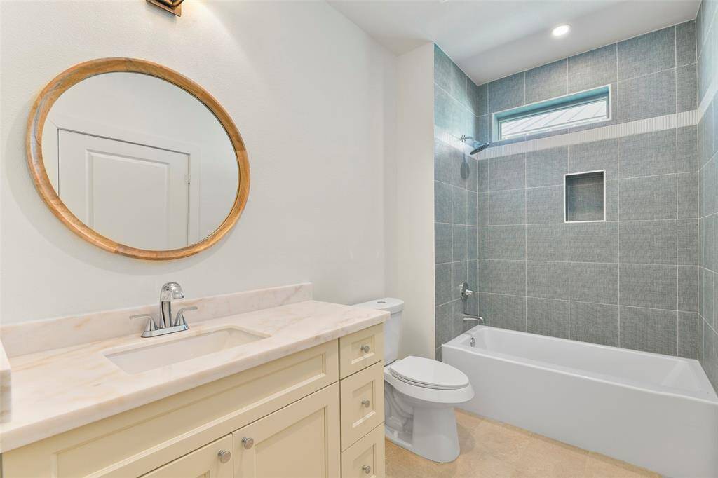 This bathroom features distinctive designer finishes, creating a stylish and sophisticated atmosphere.