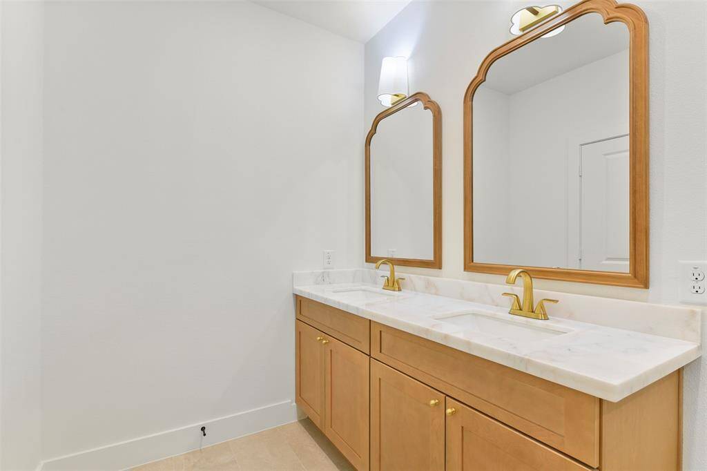 This bathroom boasts unique, carefully crafted designer finishes that elevate its elegance and charm.