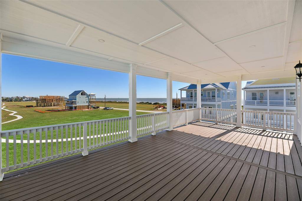 FULL OCEAN VIEWS and a walking path! The top floor back deck is a luxurious retreat, featuring enclosed beauty banding, recessed lighting, and expansive Gulf views. It’s the perfect spot to relax and enjoy coastal living, day or night.