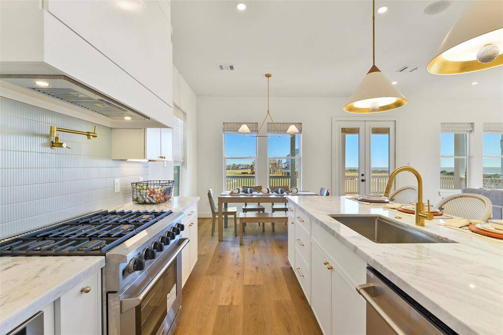 Outfitted with a sleek stainless steel Thor dishwasher, gas range, and top-of-the-line hood, this kitchen combines modern design with functionality—offering the perfect space to transform meals into lasting memories.