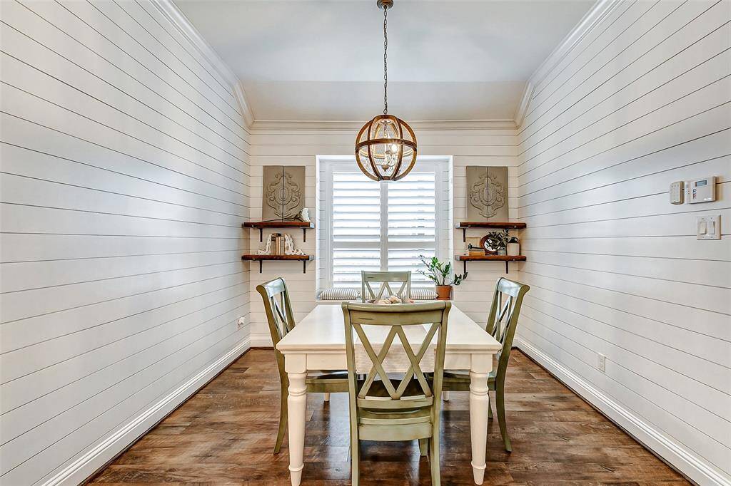 Just off the kitchen is the charming breakfast room, perfect for casual dining. It features floor-to-ceiling shiplap walls, added to the home in 2019, adding both character and warmth.