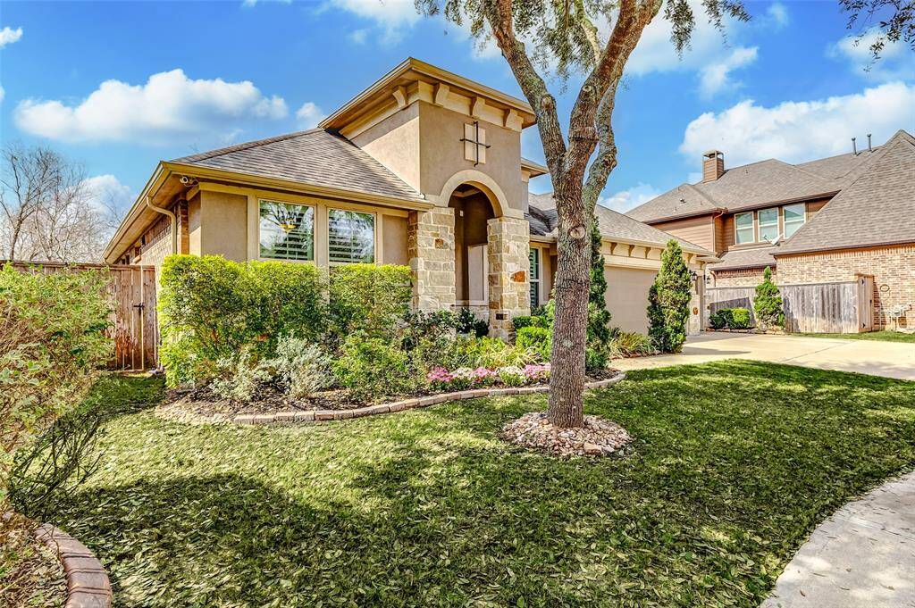 Curb appeal is A+ with a traditional stone and stucco exterior, double pane windows and professionallandscape.