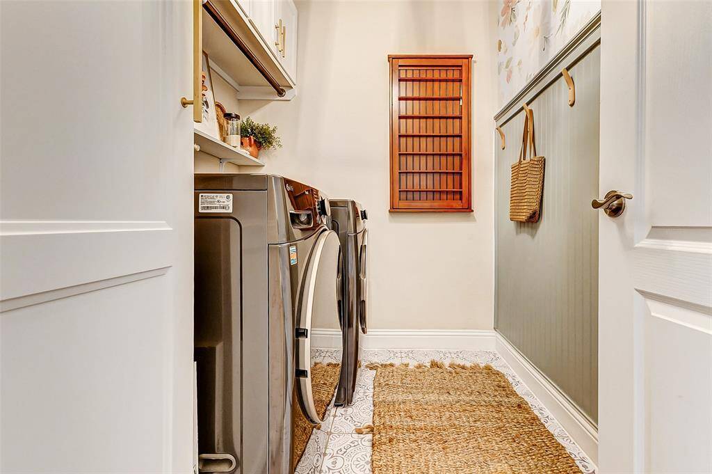What a fantastic utility room! It offers plenty of space for your preferred front- or top-load washer and dryer. Built-in cabinets, added in 2022, provide the perfect storage for detergents and cleaning supplies. Don't miss the stylish accent wall that adds a touch of charm to the space!