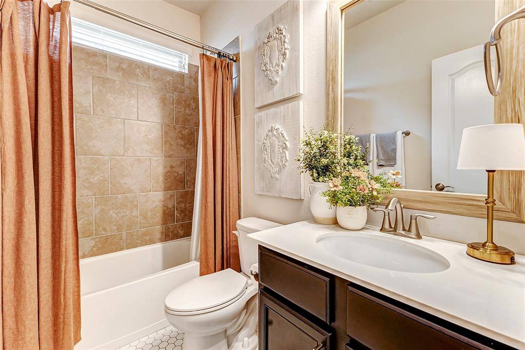 Guests will be impressed by this stunning full bathroom, featuring updated tile floors installed in 2022, a shower/bath combo, and top-of-the-line finishes throughout.