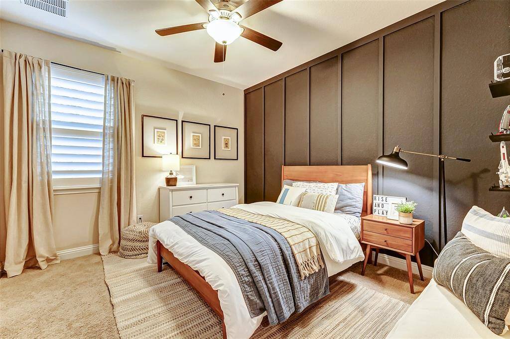 Wow! What a striking accent wall to greet each guest upon arrival! Additional features include a large window that floods the space with natural light, plush carpeting, and a ceiling fan for added comfort.