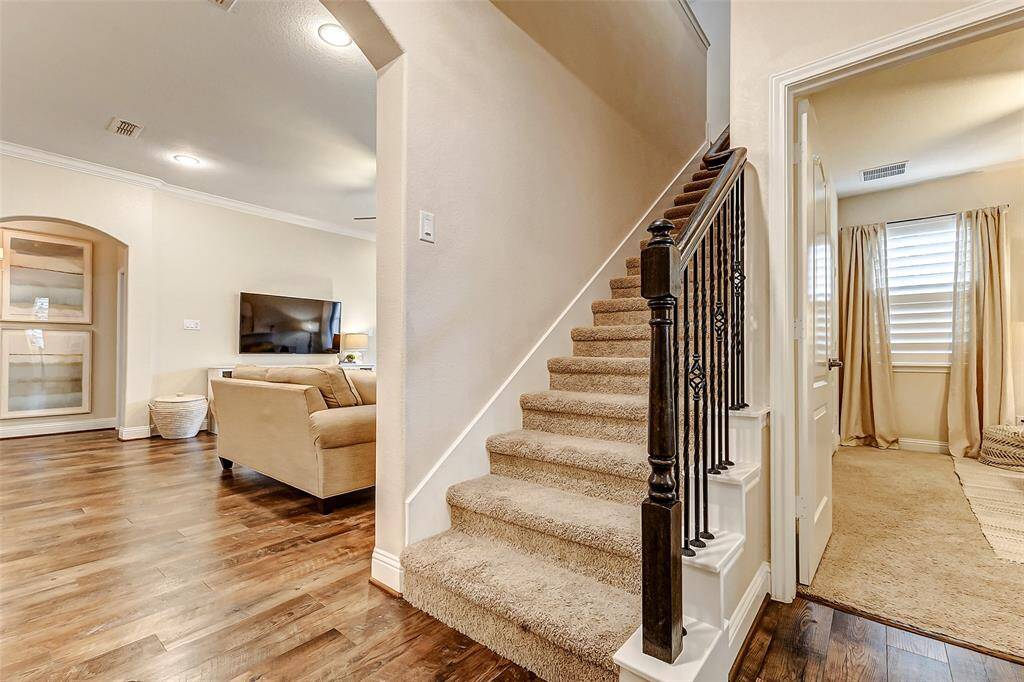 Ascend the staircase with elegant iron spindles to the second level, where you'll discover a spacious, expansive game room/flex space.