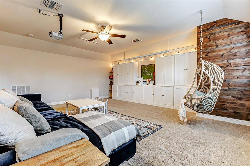Wow! What an incredible space! This room features plush carpeting, subtle wall backlighting, and another stunning rustic shiplap accent wall.
