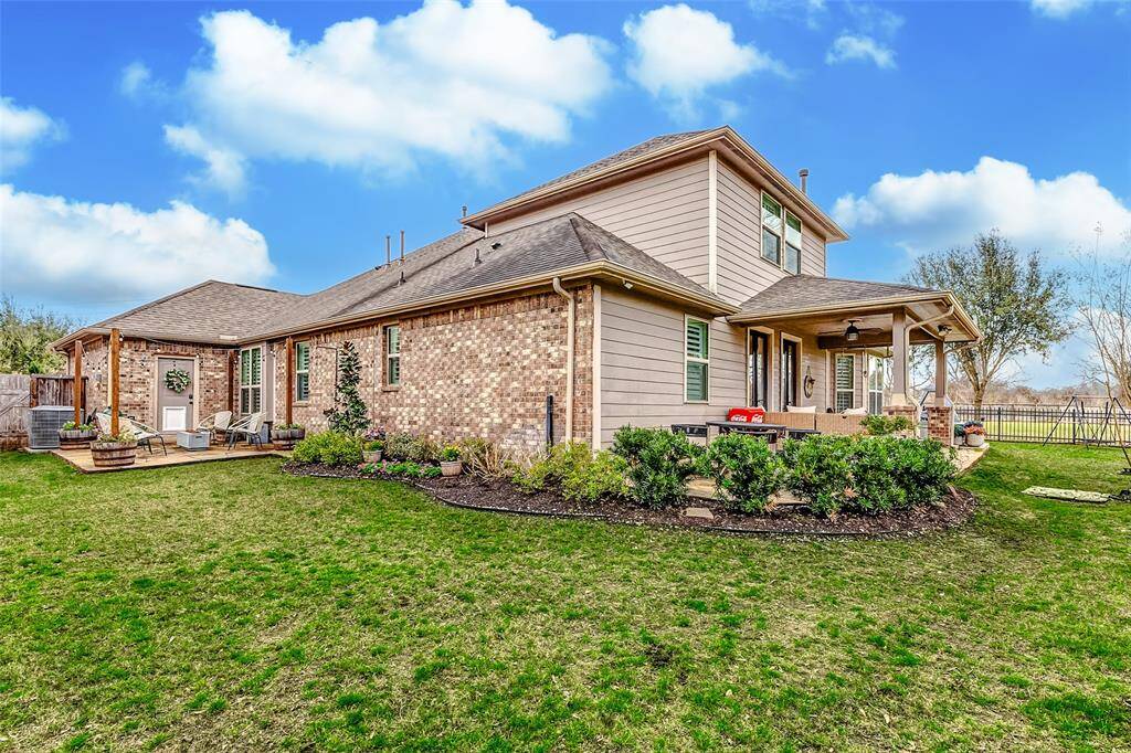 The backyard boasts two inviting seating areas and professional landscaping. Despite all the thoughtful improvements, there's still plenty of lush green space for the family to play or pets to roam freely.