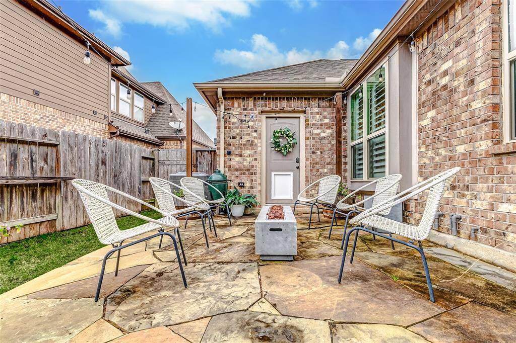 This flagstone seating area creates an intimate space to enjoy quality time with family and friends. Plus, it offers convenient access to your garage, making it both functional and inviting.