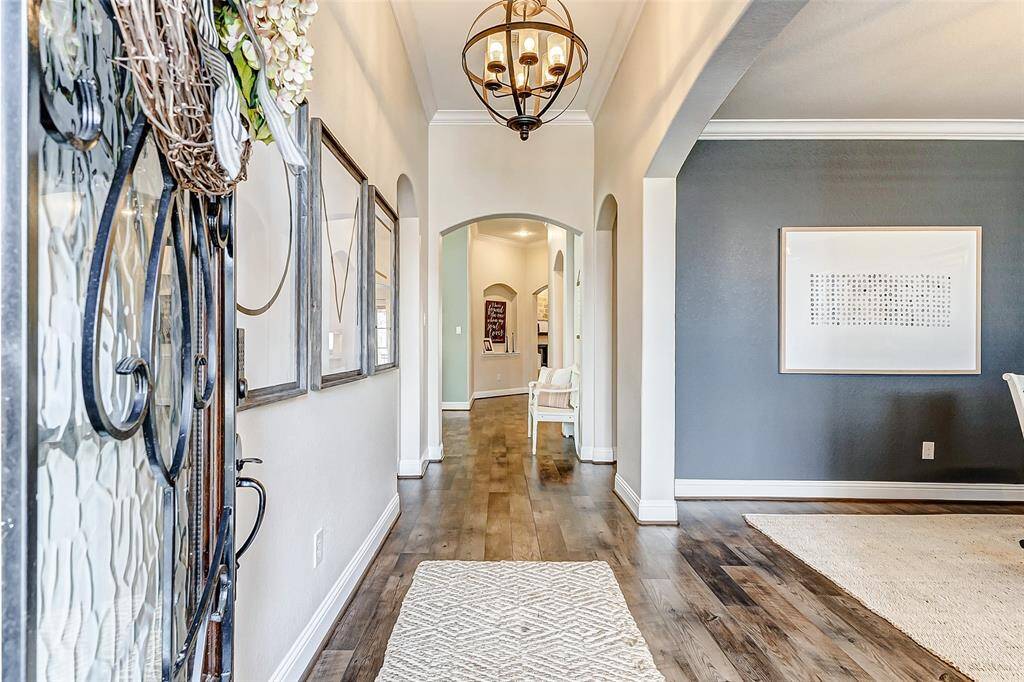 WELCOME HOME! Step inside and fall in love! As you enter, you're greeted by soaring ceilings, designer paint, exquisite luxury vinyl plank floors, and a striking overhead light fixture.