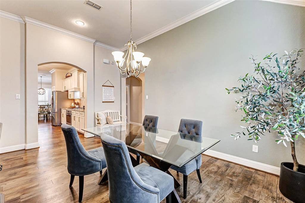This spacious dining room is perfect for entertaining, easily accommodating a large table for up to eight guests. You'll also appreciate the seamless access to the kitchen for effortless hosting.