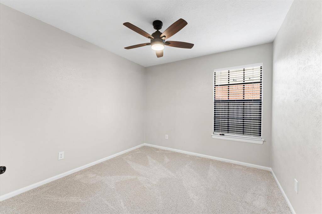 Front Secondary Bedroom, equipped with remote control ceiling fan