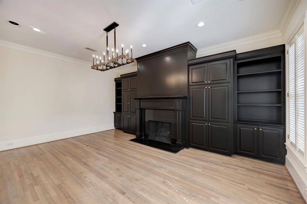 Office or Living Room complete with fire place & a wall of built-ins. Far wall could be opened to flow into the Family Room for a more open concept.