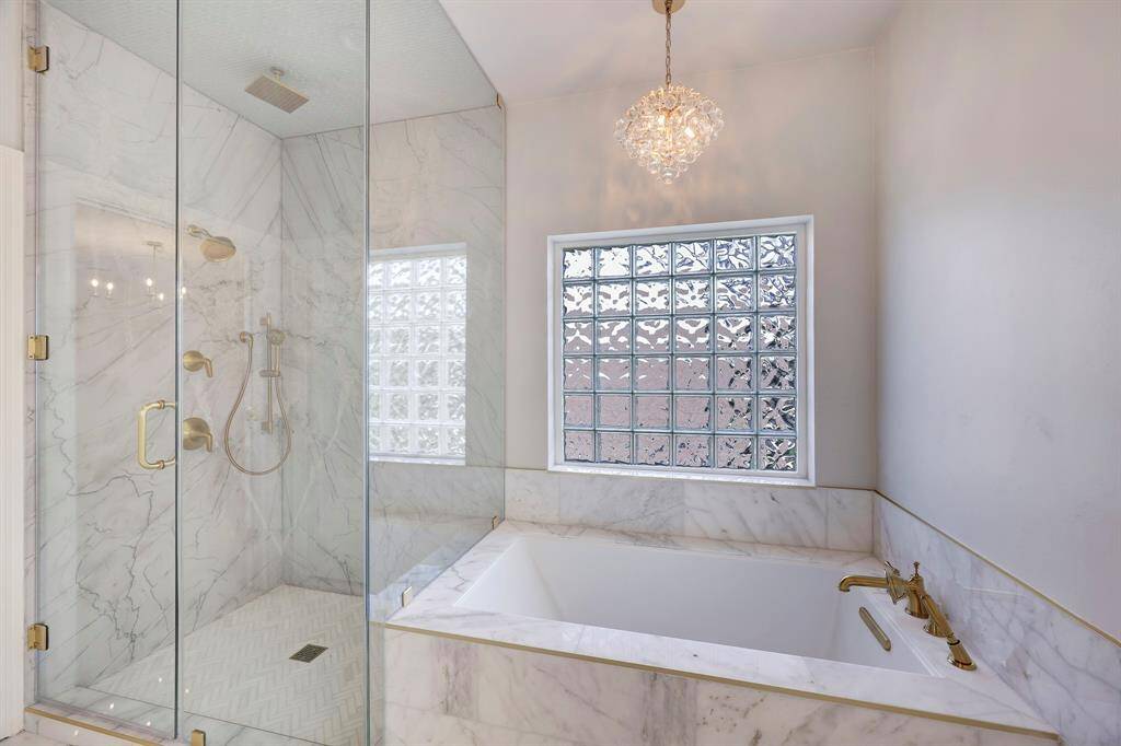 Primary Bath with marble finishes, steam shower & soaking tub.