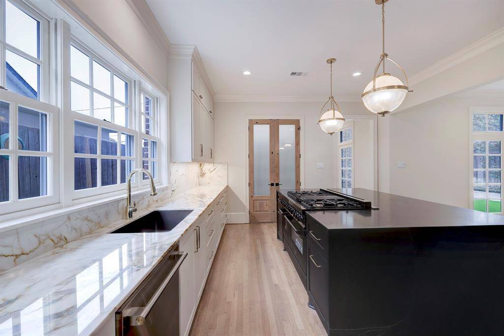 Another view of the Kitchen looking towards the custom made pantry with wooden double doors & frosted glass.