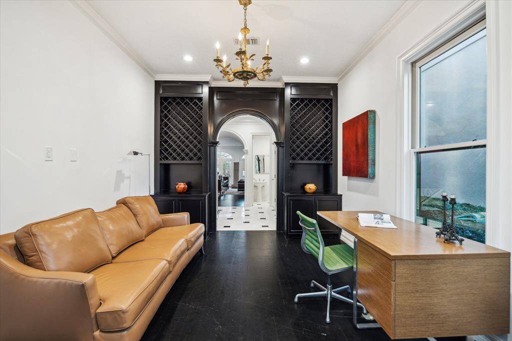 STUDY - An antique chandelier and recessed lighting enhance the warmth and sophistication of this space. The combination of upper open shelving and lower cabinetry ensures ample storage while maintaining a polished aesthetic.