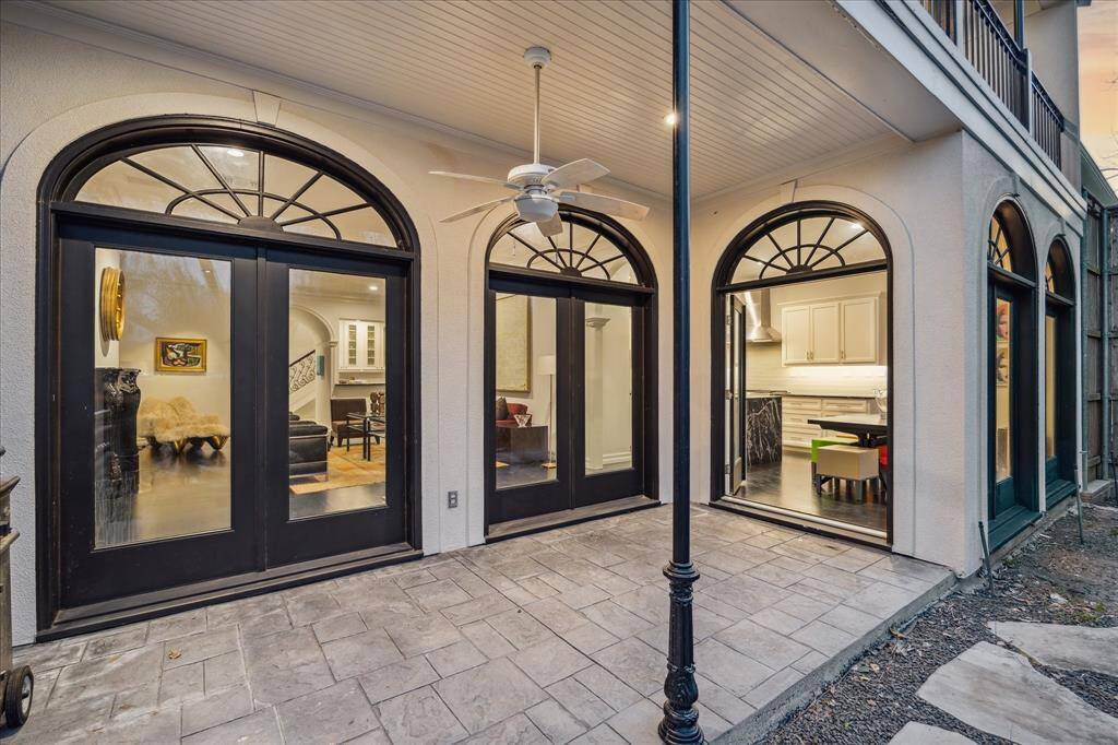 COVERED PATIO - An expansive covered patio extends the living space outdoors, ideal for year-round gatherings. With ample room for seating and dining, this shaded retreat overlooks the natural beauty of the backyard.