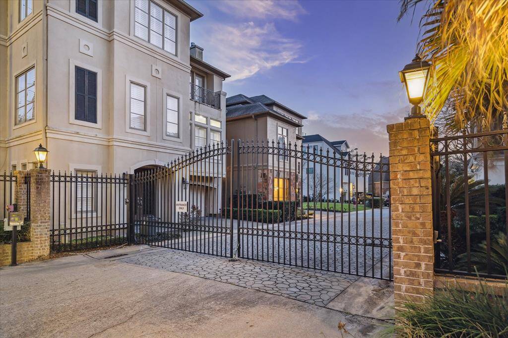 GATED ENTRANCE - The private, gated entrance to Indian Bayou offers residents a secure and serene retreat in the heart of Tanglewood. Controlled access enhances privacy while maintaining the convenience of city living