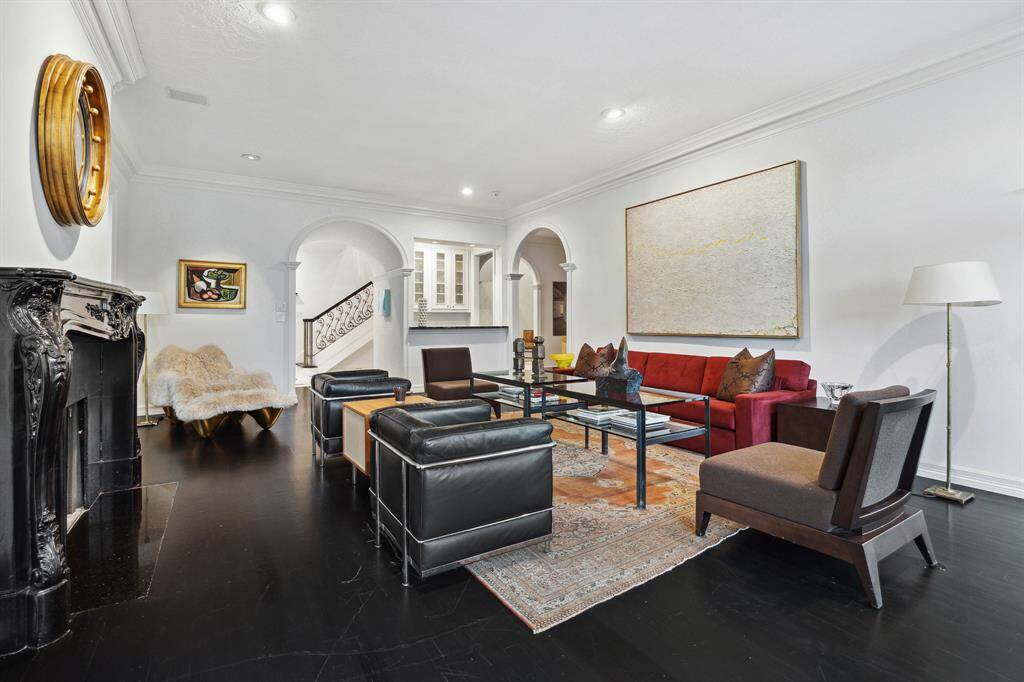 LIVING ROOM - This spacious living area seamlessly connects to the wet bar and foyer, making it ideal for entertaining. Thoughtfully placed recessed lighting and neutral designer paint create an airy atmosphere.