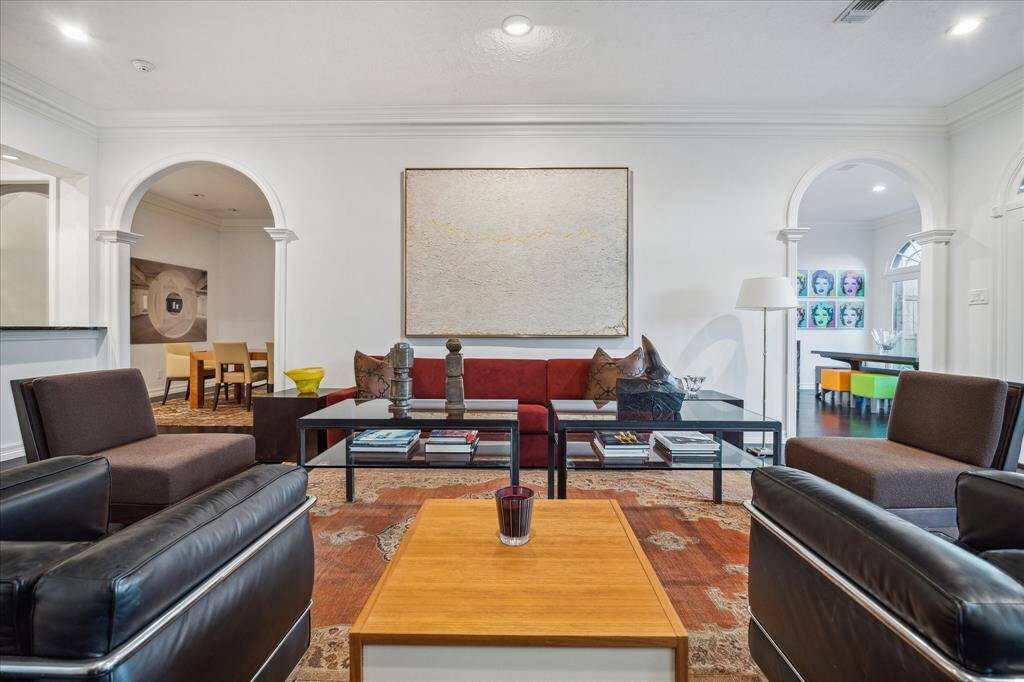 LIVING ROOM - This spacious living area seamlessly connects to the wet bar and foyer, making it ideal for entertaining. Thoughtfully placed recessed lighting and neutral designer paint create an airy atmosphere.