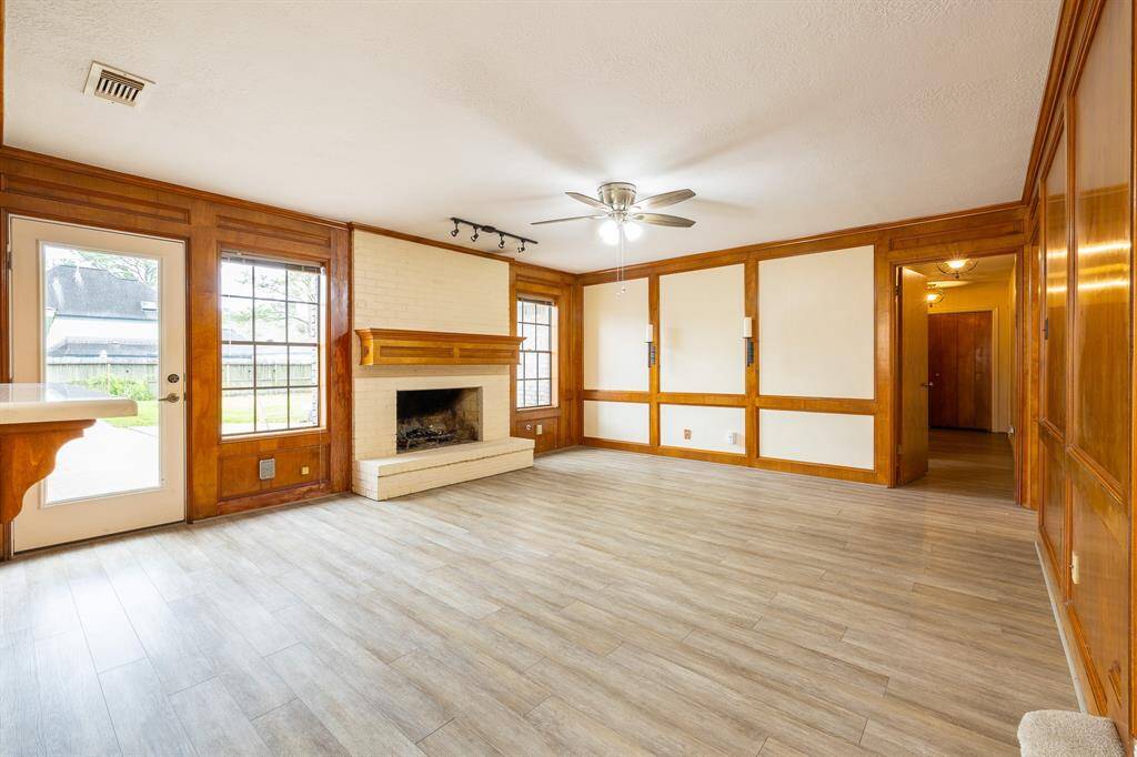 Spacious living room with cozy fireplace.