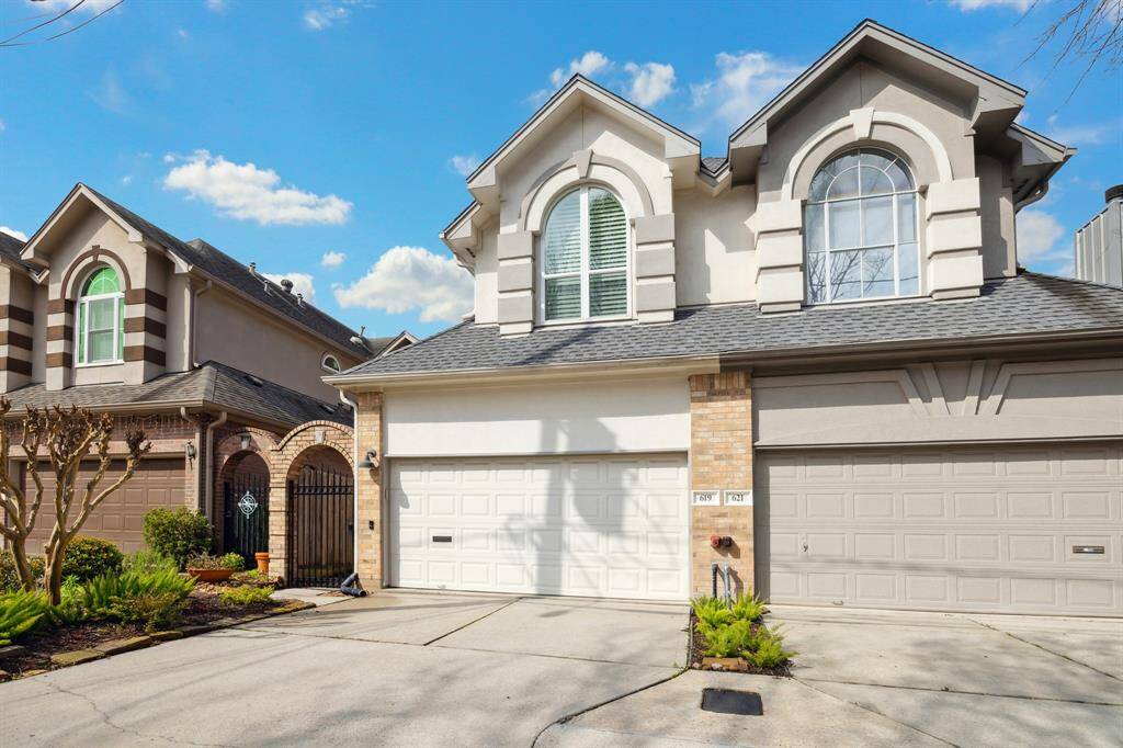 Alternate view of this meticulously maintained home highlights its abundant parking space, attractive landscaping, and secure gate.
