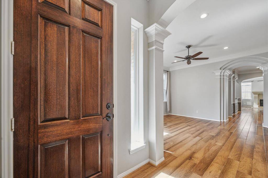 Upon entering this timeless home, you're greeted by gleaming wood floors that reflect abundant natural light, creating a warm and welcoming atmosphere. The space is beautifully enhanced by intricate molding and elegant arches, adding a touch of sophistication and classic charm to the interior.