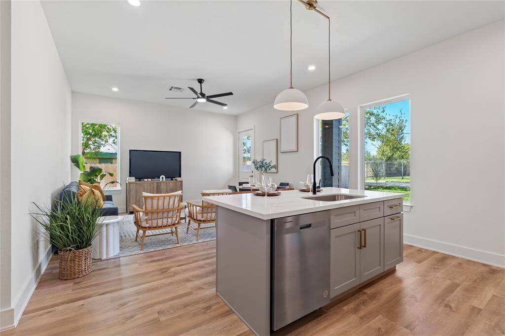 The open-concept design seamlessly connects the kitchen, living, and dining areas for a spacious feel. A functional layout perfect for modern living and entertaining
