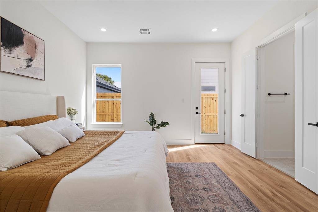 The primary bedroom features direct backdoor access to the backyard, offering a private and seamless connection to outdoor space.