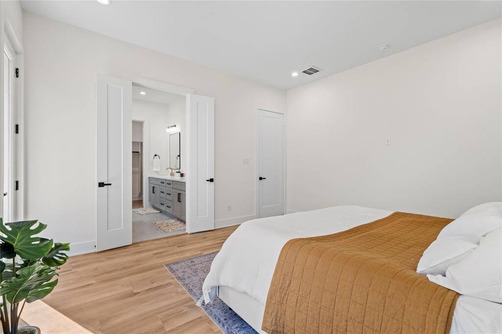 Double doors lead into the luxurious ensuite, adding an elegant touch and a sense of privacy to the space.