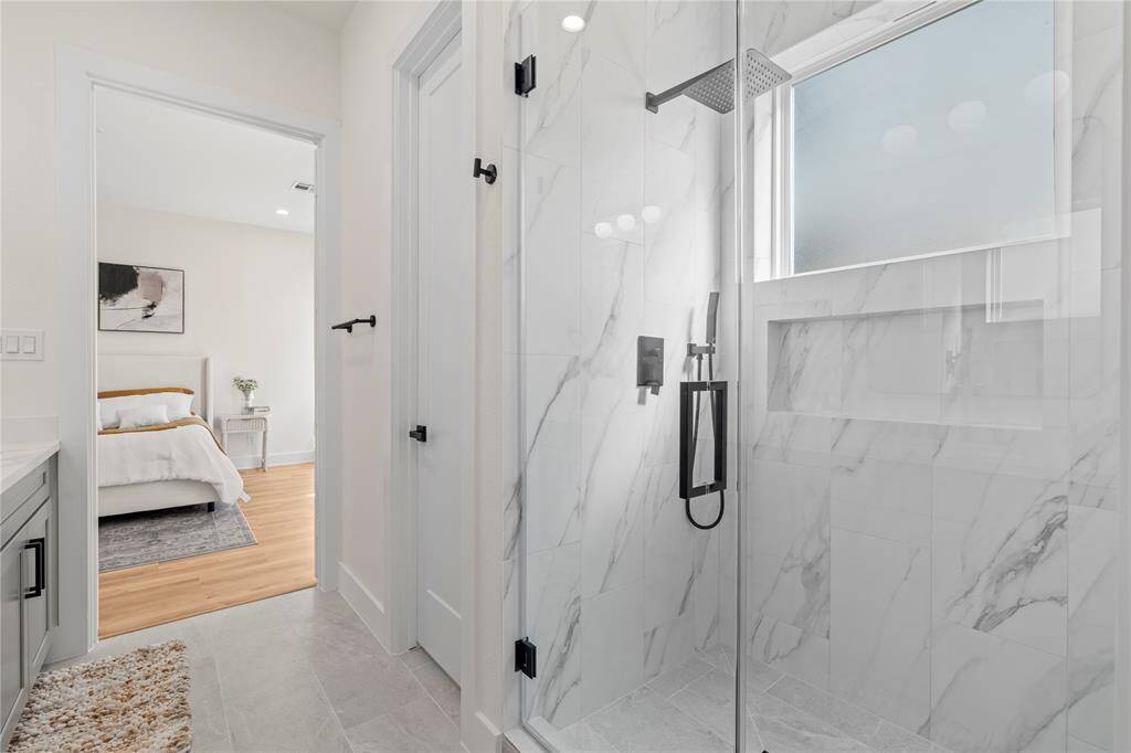 The frameless walk-in shower offers a sleek, modern look with clean lines and an open, spacious feel with an oversized shampoo niche