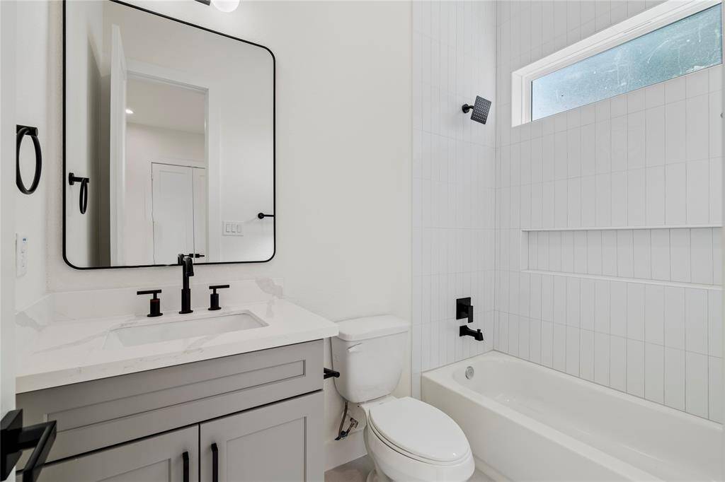 The secondary bathroom, attached to the bedroom, offers sleek design and convenience, making it a perfect private retreat for guests or family.