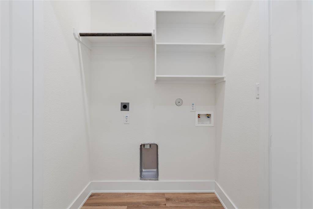 The large utility room offers plenty of space for laundry and additional storage, keeping your home organized and functional