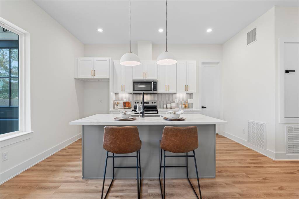The kitchen is filled with natural light, creating a bright and inviting space for cooking and gatherings