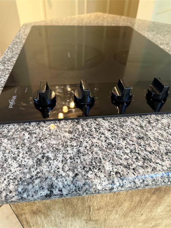 granite countertop around island  cooktop