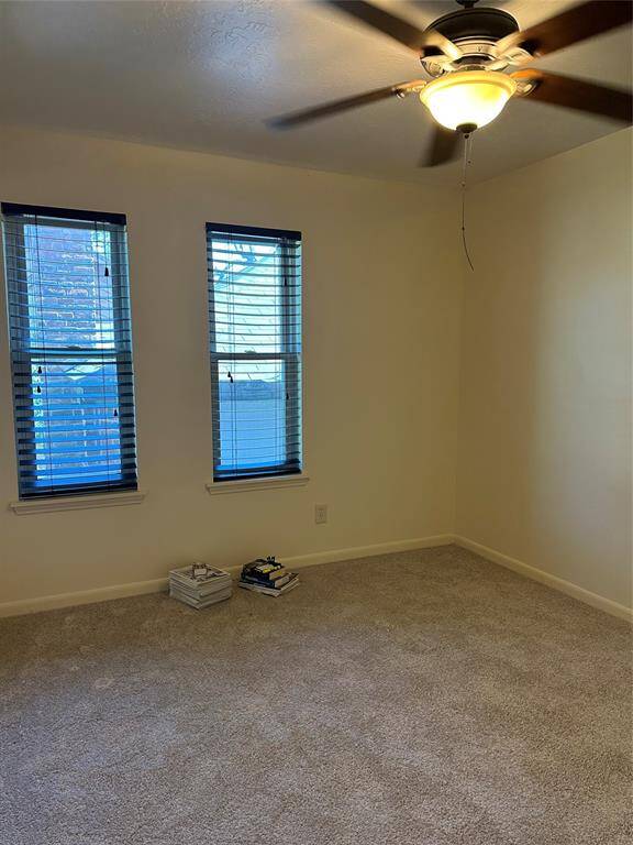 third bedroom with ceiling fan