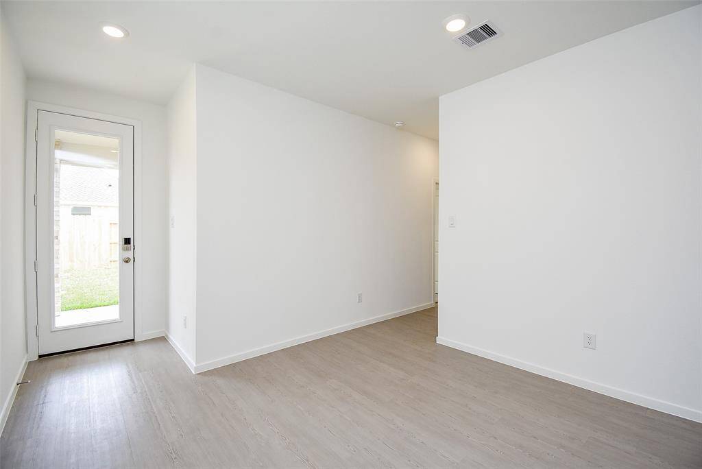 Another view of the dining space/back door.  All flooring is luxury plank vinyl.  Easy to care for and durable. (staged)