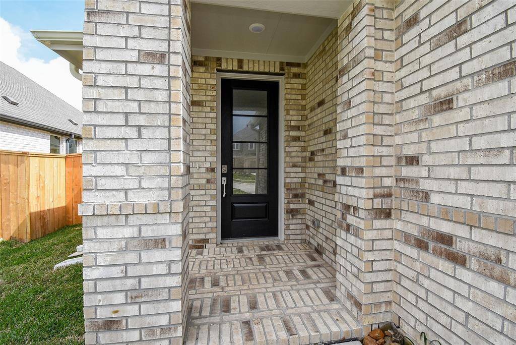 Covered front patio. All brick construction.