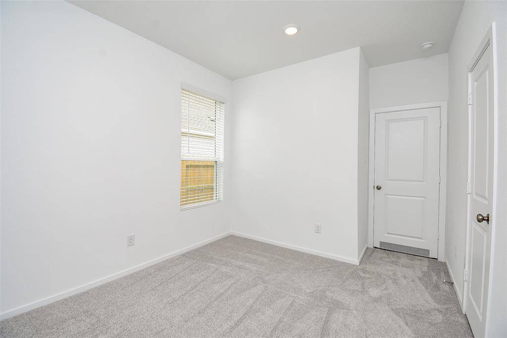 Secondary bedrooms in this split plan are off the living room.  This room has a single window and closet on the right.