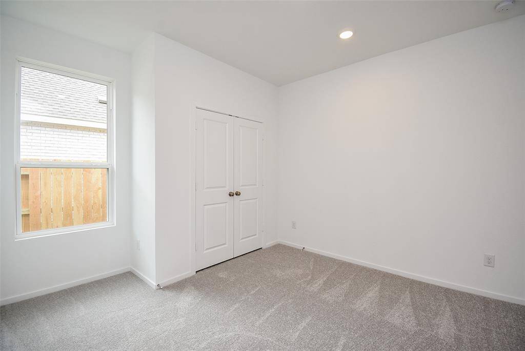 Another secondary bedroom with single window and closet. (staged)