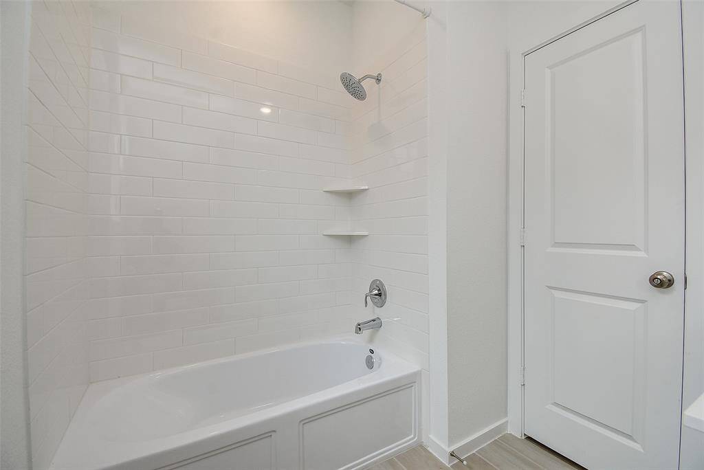 Combination shower/bath with subway tile.