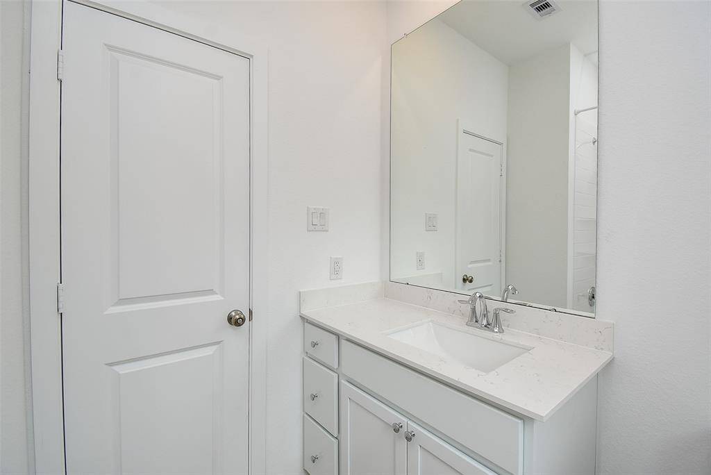 Undermount sink with large mirror above.