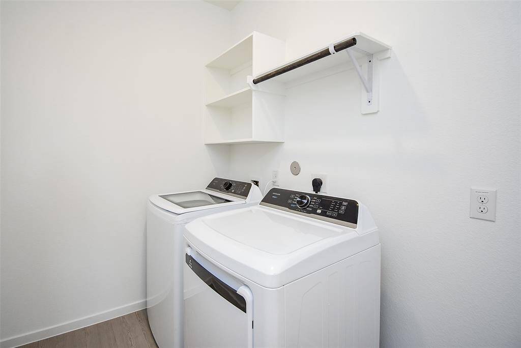 Brand new washer and dryer!  Additional space for an upright freezer and shelves above make this a great space.