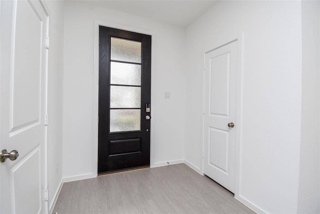 Frosted glass door protects your privacy. Coat closet as you enter. Garage door on left.