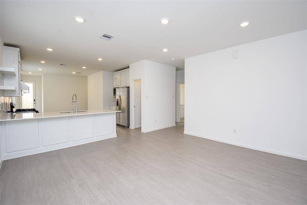 You will feel space and light when you enter the home. This space is the heart of the home with living room, kitchen and dining all in one. (staged)