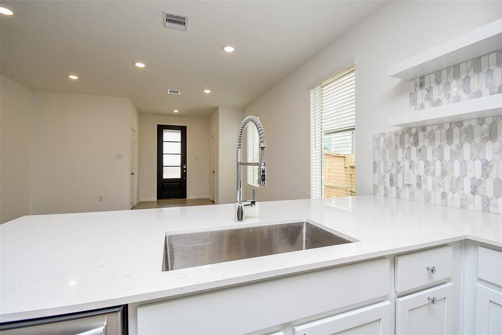 You will enjoy this deep farmhouse style sink with disposal and stylish pre-rinse faucet.  Countertops are quartz.