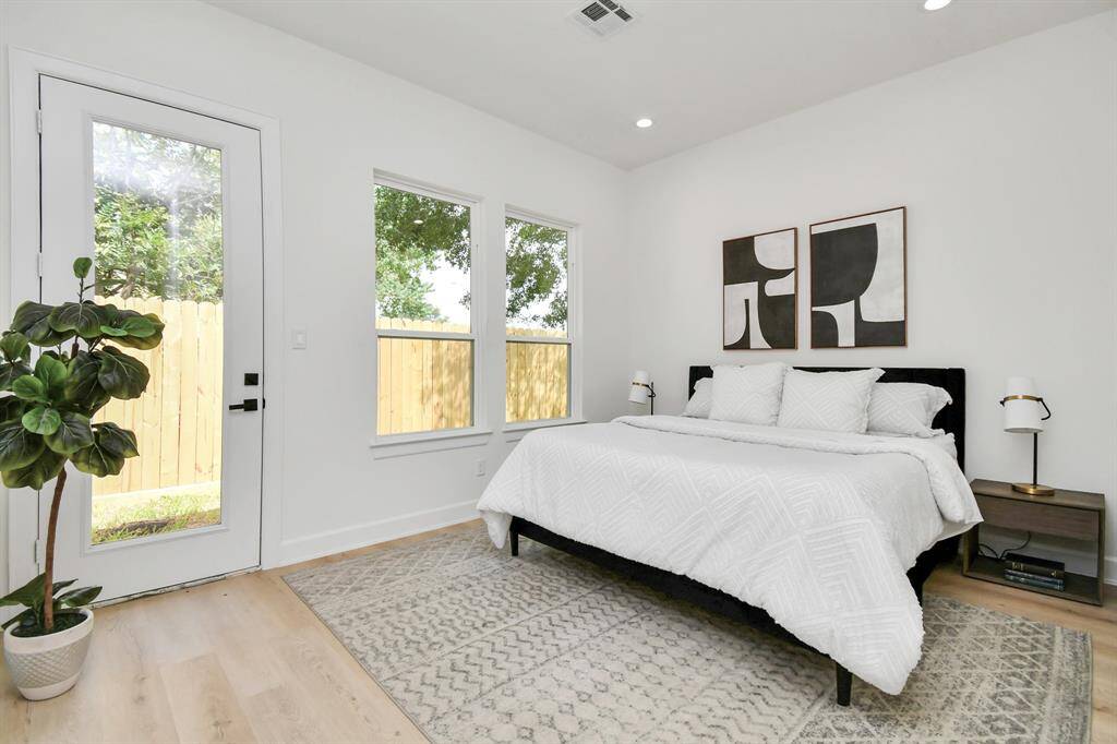 The expansive primary bedroom offers ample space and a luxurious feel, seamlessly flowing into your private ensuite bathroom. This tranquil retreat features high ceilings and large windows, enhancing the room's openness and inviting natural light.