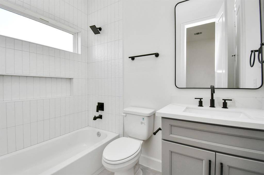 Each secondary bedroom is complemented by a full-sized bath featuring floor-to-ceiling tile in the shower and tub area. This luxurious design enhances the space with a sleek, modern look and provides a touch of sophistication and durability.