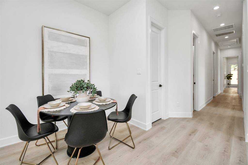The dining area is discreetly tucked away, enhancing the functional flow of the floor plan while maintaining an overall open and spacious feel.