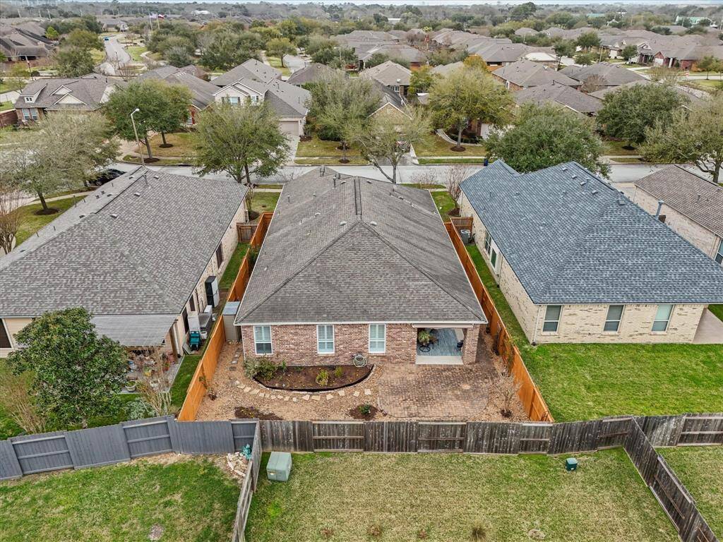 Low-maintenance back yard with large cobble stone patio extension. Brick on all 4 sides!